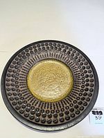 Full top view of the large Upsala Ekeby ceramic plate/platter showing textured and patterned surface in brown, gold, and green tones.