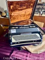 Accordion in open case showing keyboard and interior