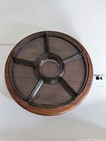 Top view of round teak Lazy Susan with 6 smoked glass bowls in compartments