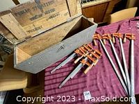 Photo showing ten Jorgensen F-Clamps grouped beside a vintage wooden box, displaying the overall lot contents and size relationship.
