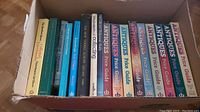 Box containing multiple antique price guide books in various editions and topics.