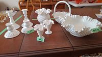 Photo showing all nine pieces including four candlestick holders, three vases, one candy or nut dish, and one large bowl