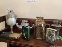 All seven lighters arranged on wooden surface showing table and pocket styles