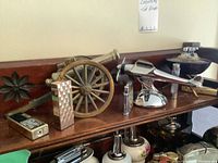 Top shelf overview showing eight metal novelty lighters in various designs