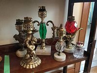 Wide shot of all six glass and metal table lighters on shelf