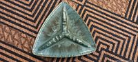 Top view of large Blue Mountain Pottery triangular ashtray with greenish-blue glaze and three cigarette rests.