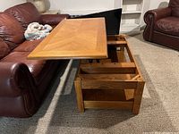 Coffee table top extended upwards showing internal storage