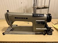 Side view of Consew 230 sewing machine showing overall condition and model name plate