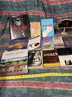 Photo showing 11 assorted books including Harley Davidson, allergy relief, personal finance, travel, health, poetry and literature topics.