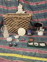 Photo showing all items: three angels, woven basket, unicorn figure, various ornaments including Santas, house, patches, and a boxed medal.