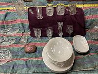Full overhead view showing entire collection spread on a cloth, includes plates, bowls, glasses, and pitcher.