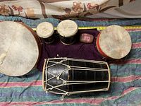 Top view of the entire drum lot including all drums placed on a striped cloth.