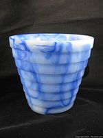 Front and side view of blue and white swirl slag glass vase with tiered ring design