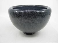 Front angled view of purple and silver textured glass bowl showing rounded shape and rim