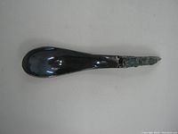 Top view of the spoon showing smooth rounded bowl and raven design on handle front.