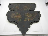 Pair of black vintage Chinese chinoiserie folding wall shelves, flat on white background showing painted bird and floral designs with scalloped edges, with missing center supports.