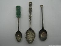 Front view of all three spoons showing design details and size comparison.
