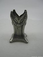 Photo showing side profile and detailed top leaf motif of the small WMF metal piece.