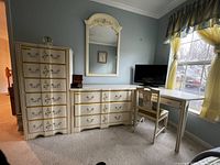 Full view of chest of drawers, single dresser, mirror, corner desk and chair arranged against wall