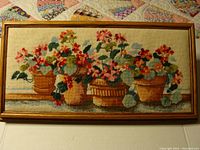 Framed petit point needlepoint needlepoint featuring floral potted plants detail and overall view