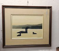Framed oil painting of two loons on a lake at sunset, signed by G.A. Keirstead.