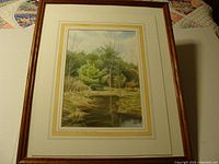 Framed watercolor painting showing the overall view of the artwork with visible matting and dark wood frame.