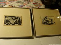 Both framed charcoal drawings by Ray Robinson displayed together