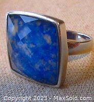 Front angle showing the blue facetted square stone set in silver