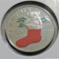 Close-up front image showing a silver coin with a colored design of a teddy bear in a red stocking and green branches, date 2006 and denomination 25 cents