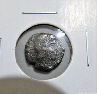 Front side of the anonymous ancient Roman coin showing worn and corroded imagery and inscription.