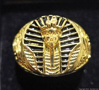 Close-up front view of the gold plated King Tut ring showing detailed Pharaoh head with black enamel background.