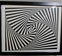 Full view of the framed ink art featuring a geometric spiral pattern in black and white.