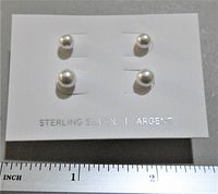 Front view of two pairs of sterling silver earrings with round faux pearls on white card with measurement ruler