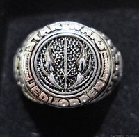 Close-up photo of a sterling silver ring face with Star Wars Jedi Order emblem and engraved text