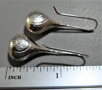 Pair of vintage sterling silver teardrop-shaped earrings placed beside a ruler for size reference; earrings measure approximately 1 inch