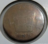Front close-up photo of the worn Freemason penny token showing faded Freemason symbols and inscription with visible wear marks.