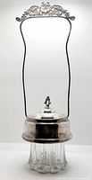 Full view of the pickle cruet showing the clear glass base, silver plated lid with handle, and overall height and form.