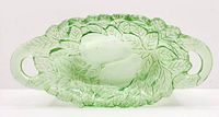 Full top-down view of green glass oval relish dish showing pear, avocado, and leaf embossing with double open handles at each end.