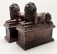 Pair of bronze-finished lion book ends shown side by side at an angle, highlighting their size and sculptural detail