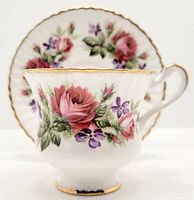 Front view of Paragon floral tea cup with saucer in background.