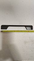 Cabinet handle shown with measuring tape indicating 7.5 inch center-to-center mounting holes and about 8.5 inches overall length. Matte dark grey, almost black anthracite finish, modern sleek design.