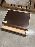 Solid wood dark brown finished rectangular drawer with natural wood interior, open showing inside from above angle.
