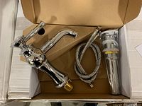 Chrome finished faucet, hoses, and drain assembly in box