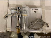 Chrome bathroom faucet, pop-up drain, and water supply hoses on white box featuring LUKX branding