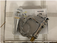 Chrome bathroom faucet with installation parts including hoses, in plastic wrapping, sitting on a LUKX Splash branded box.