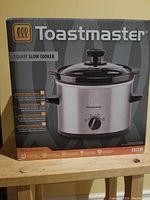 Box of Toastmaster 2 Quart Slow Cooker showing front with brand and product image.