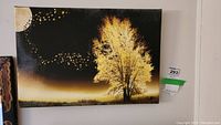 Full view of canvas print showing yellow tree, white crescent moon, and gold accents against dark background