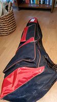 Photo of the black and red carrying bag containing the fencing equipment.