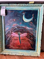 Framed original painting showing full view of the dragonfly flying beneath a crescent moon and starry sky with blue frame