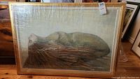 Full front view of framed painting shrink-wrapped